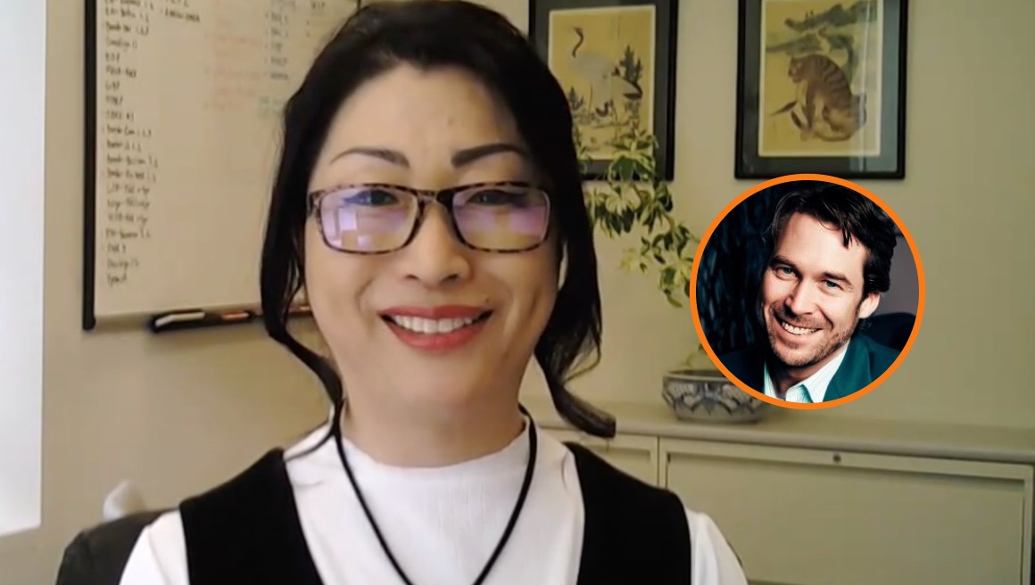 A woman with glasses and a white top smiles in an office, with a whiteboard, shelves, and framed art behind her. An inset shows a smiling man in a suit in front of a blurred background.