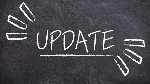 The word UPDATE is written in large white chalk letters on a black chalkboard, with lines and rays drawn around it to emphasize the text.